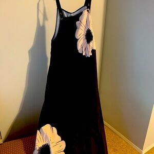 Black jumpsuit with cream colored floral pattern and side pockets. New.